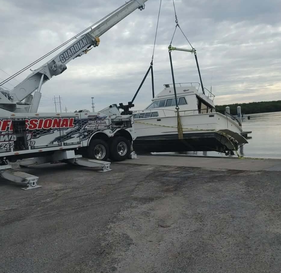Crane lifting a boat out of the water for removal